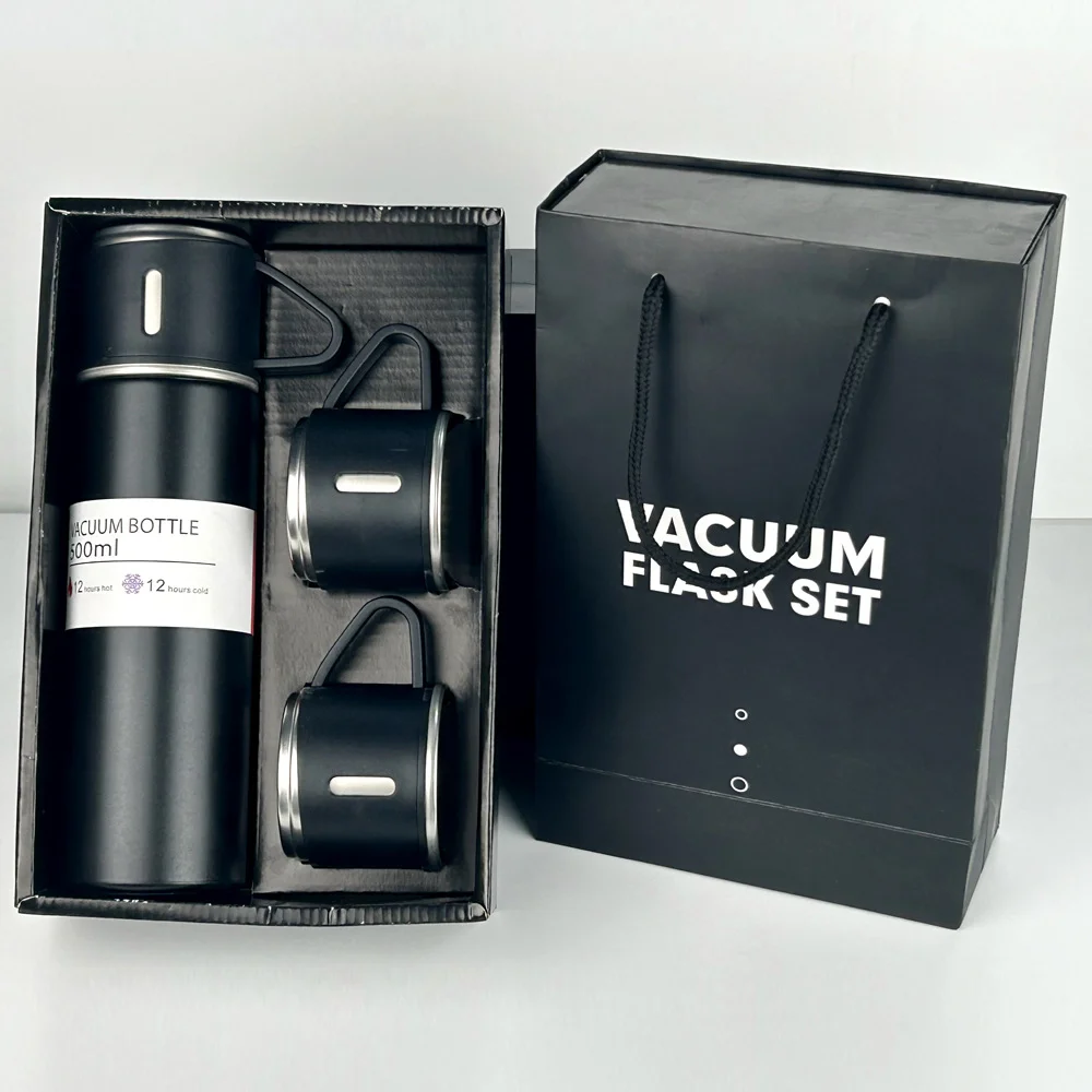 Black vacuum flask set featuring a large flask and two cups in a box alongside a matching gift bag.