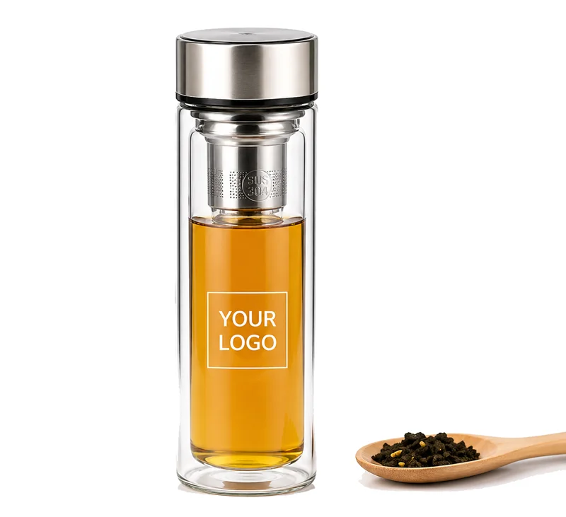Double-wall glass tea bottle with stainless steel infuser and a wooden spoon with loose tea leaves.