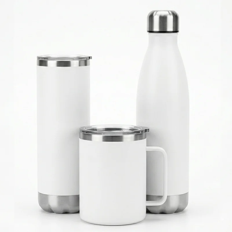 Set of stainless steel tumblers and a mug with white finish and silver accents on a plain background.